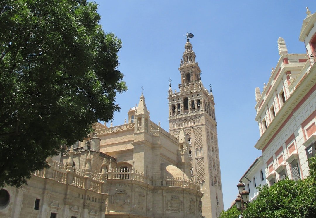 The giralda tower stands tall under a clear sky.