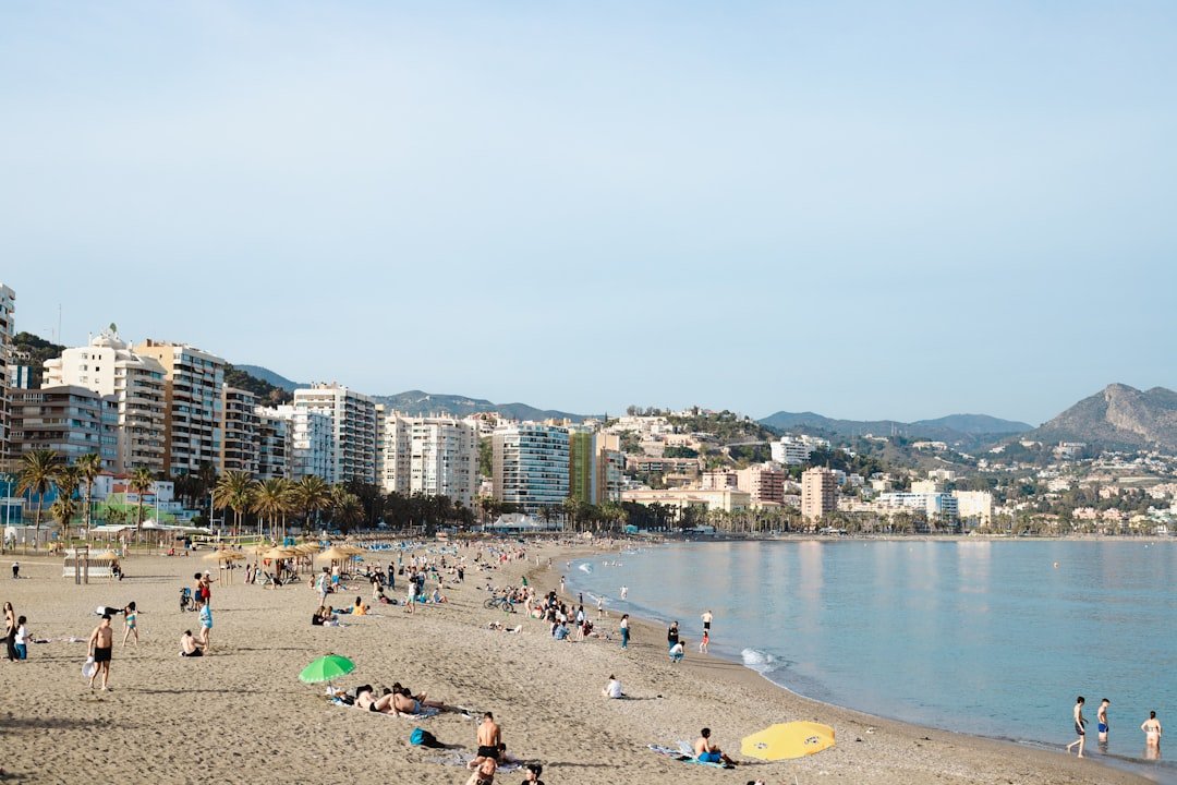 a crowded beach with people in Malaga